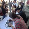 Peter Meehan and David Chang sign copies of their book.