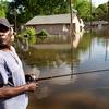 William Jefferson fishes in the street near his flooded home in the King's Community neighborhood May 11, 2011 in Vicksburg, Mississippi. 