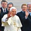 Pope Benedict XVI greets a crowd while on a visit to Australia. By his side is Prime Minister of Australia Kevin Rudd.