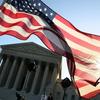 A person carries an American flag while marching in favor of the Patient Protection and Affordable Care Act in front of the U.S. Supreme Court on March 26, 2012 in Washington, DC. (Getty)