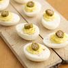 Slices of Rick's Picks Smokra on top of deviled eggs