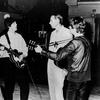 George Harrison, Paul McCartney and John Lennon with George Martin.
