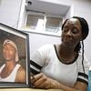 Veronica Parker holds a photo of her late son, Korey B. Parker, Sr., 27, at her workplace. Parker is a member of Purpose Over Pain, a support group for parents who've lost children to gun violence. 