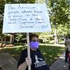 A protester stands outside the house of Senate Majority Leader Mitch McConnell, R-Ky., in Louisville, Ky., Saturday, Sept. 19, 2020. McConnell vowed on Friday night, hours after the death of Ginsburg.