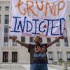 Nadine Seiler protest as she holds a banner outside federal court Tuesday, Aug. 1, 2023 in Washington. Former President Donald Trump has been charged by the Justice Department for his efforts to overt