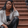 Whitney White poses on the steps of a brownstone apartment. 