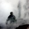 This US Navy photo released 17 September, 2001, shows a firefighter emerging from the smoke and debris of the World Trade Center September 14, 2001. 