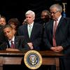 US President Barack Obama signs the Dodd-Frank Wall Street Reform and Consumer Protection Act alongside members of Congress, the administration and US Vice President Joe Biden