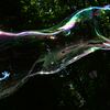 A boy plays on May 28, 2013 with soap bubbles during the Share Drive of Life charity event organized by the Kiev Chapter Ukraine motorcycling club for children with autism in a park in Kiev.