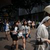 Nuns walk on a popular shopping street in Seoul on July 6, 2013. Freedom of religion is constitutionally guaranteed in South Korea, which is predominantly Buddhist and Christian.