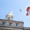 The New York City flag flies outside New York City Hall. 