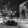circa 1945: View of the lights of cars at night in front of the Washington Arch in Washington Square Park, Greenwich Village, New York City