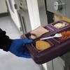  A guard serves lunch to an immigrant detainee in his 'segregation cell' during lunchtime at the Adelanto Detention Facility on November 15, 2013 in Adelanto, California.