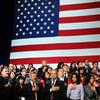 Audience takes the pledge of allegiance before US President Barack Obama speaks on immigration reform at Betty Ann Ong Chinese Recreation Center in San Francisco, California, on November 25, 2013