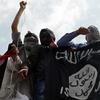 Kashmiri demonstrators hold up a flag of the Islamic State of Iraq and the Levant (ISIL) during a demonstration against Israeli military operations in Gaza, in downtown Srinagar on July 18, 2014. 