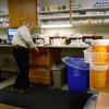 Pharmacist Hank Wedemeyer fills prescriptions as generic diabetes medicine awaits distribution at a community health center for low-income patients on December 1, 2009 in Aurora, Colorado.