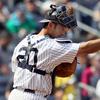 Jorge Posada #20 of the New York Yankees points to teammate pitcher Phil Hughes (not pictured) after a sixth inning strike out against the Chicago White Sox on May 2, 2010