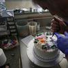Masterpiece Cakeshop owner Jack Phillips decorates a cake inside his store, in Lakewood, Colo. Phillips is appealing a recent ruling against him in a legal complaint filed.
