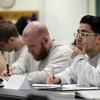 In this photo taken Thursday, Jan. 28, 2016, Rudy Madrigal, center, looks on as he sits with fellow inmates in a a college world history class at the Monroe Correctional Complex in Monroe, Wash. 