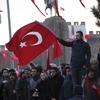 People wave national flags as they protest after a car bomb attack in central Anatolian city of Kayseri, Turkey, late Saturday, Dec. 17, 2016. More than a dozen Turkish troops were killed.