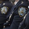 Police brass listens as New York City Mayor Bill de Blasio, and NYPD Commissioner Jim O'Neil conduct a news conference, Jan. 4, 2017, in New York. NYC recorded its fewest number of shootings last year