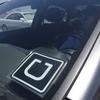  In this July 15, 2015, file photo, Uber driver Karim Amrani sits in his car parked near the San Francisco International Airport parking area in San Francisco. 