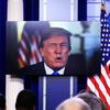 President Donald Trump speaks via a video monitor to journalists in the press briefing at the White House during the daily press briefing with press secretary Sarah Huckabee Sanders.