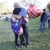 Family member embrace following a shooting at Marjory Stoneman Douglas High School, Wednesday, Feb. 14, 2018, in Parkland, Fla.