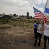 Israelis hold American and Israeli flags with the new U.S. embassy in the background in Jerusalem, Monday, May 14, 2018. Israel prepared for the festive inauguration of a new U.S. Embassy.