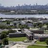  In this this June 20, 2014, file photo, the Rikers Island jail complex stands in the foreground with the New York skyline in the background. 