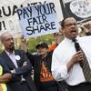 Rep. Keith Ellison, D-Minn. joins low-wage workers at a rally outside the Capitol in Washington, Monday, April 28, 2014, to urge Congress to raise the minimum wage as lawmakers return to Washington.