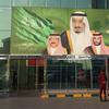 In this Dec. 14, 2015 file photo, images of King Salman, center, Crown Prince Mohammed bin Nayef , left, and Deputy Crown Prince Mohammed bin Salman hang at the entrance of a shopping center in Riyadh