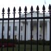 In this Sept. 23, 2014, file photo, the White House is seen through the North Lawn perimeter fence in Washington.