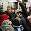 Commuter crowded on the L train as service is operating at near peak capacity.