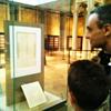 Visitors read the copy of the Declaration of Independence handwritten by Thomas Jefferson 