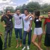 Syrian and American teens gather together on a field in summer 2017.