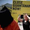 Demonstrators hold a rally to urge President Barack Obama to fulfill his pledge to close the military prison at Guantanamo Bay, Cuba, and end indefinite detention outside the White House May 23, 2014.