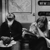 A view of three people sitting on the Number 2 line (7 Avenue Express) IRT subway, New York, 1970s. One man sleeps, a young woman reads a newspaper, and a young man eats