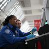  A TSA agent checks a traveler's identification at a special TSA Pre-check lane at Terminal C of the LaGuardia Airport on January 27, 2014 in New York City.