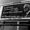 Partisans of both parties have been at work on the Barry Goldwater billboard at S. Dahlia St. and E. Evans Ave. 1964.