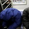 Homeless New Yorkers stay warm riding the subway as a polar vortex as the city is plunged into dangerously low temperatures.