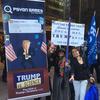 Gamer Olli Rundgren (next to sign) promotes his game at Trump Tower.