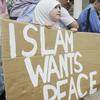 Members of the Leeds Muslim Community stand in Millennium Square to mark the two minute tribute to the victims of the London bombings on July 14, 2005 in Leeds, England.