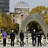 US Secretary of State John Kerry (center L) puts his arm around Japan's Foreign Minister Fumio Kishida (center R) at the memorial site in Hiroshima. 