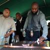 Michael Brown Sr. wipes the top of the vault during the funeral for his son Michael Brown at St. Peters Cemetery on August 25, 2014 in St. Louis Missouri. 