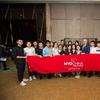 National Youth Orchestra of China poses for picture behind a red banner