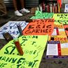 Poster and a vigil for Eric Garner at the site where he was killed.