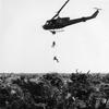 U.S. Navy SEALS repel down ropes from a U.S. Army Bell UH-1B Iroquois helicopter to set an ambush in the jungle below during operations in South Vietnam.