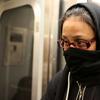 A woman on the L train covers her face, fearful after a doctor with Ebola rode the train.