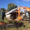A house in Staten Island's Oakwood Beach neighborhood is demolished under Gov. Andrew Cuomo's Sandy buyout program.